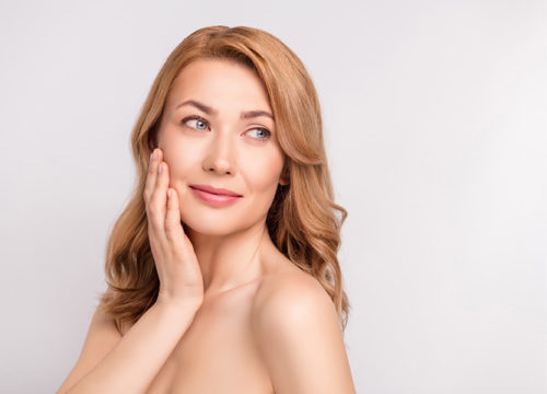 Photo of a woman touching her face